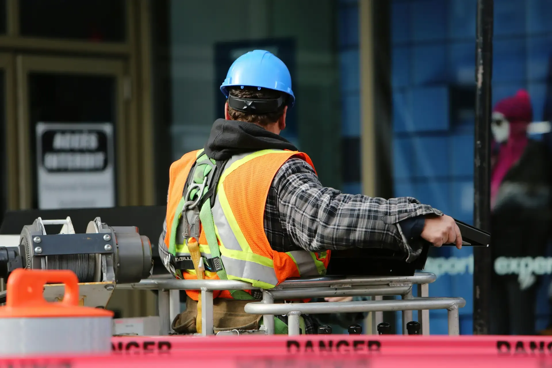 A man in a safety vest overseeing a construction site