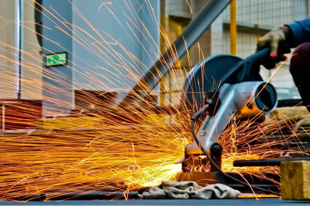 A fabricator cutting through concrete.